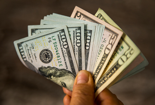 Hombre maduro irreconocible con billetes de un dólar de los Estados Unidos photo
