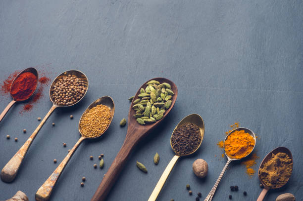 istock Variety of herbs and spices on slate background. 643760610