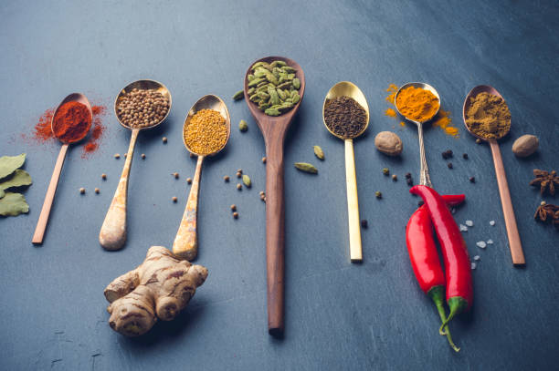istock Variety of herbs and spices on slate background. 643760616