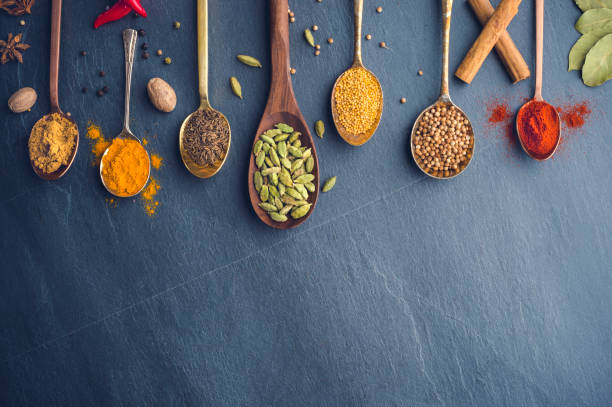 istock Variety of herbs and spices on slate background. 643760620