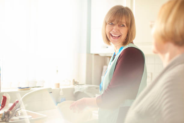 Senior carer Healthcre worker chatting to the lady she is helping meals on wheels photos stock pictures, royalty-free photos & images