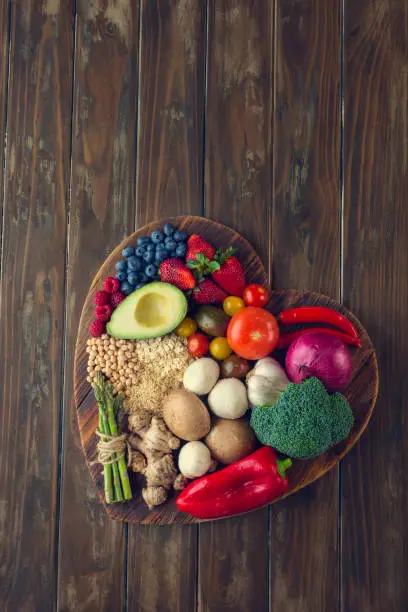 Photo of Healthy food on a heart shape cutting board