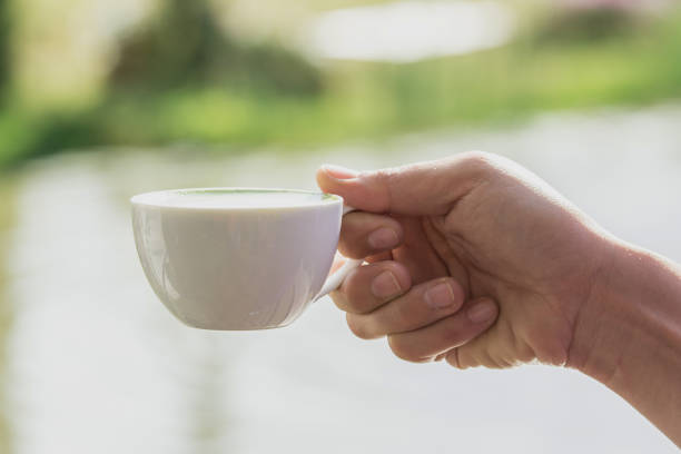 istock white cup of hot drink in a hand 643768354