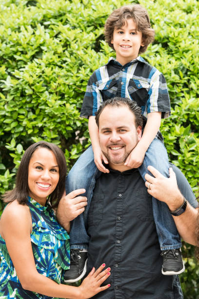 istock smiling hispanic family of three 643775300
