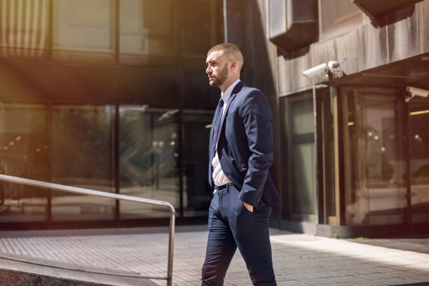 istock young confident businessman standing outdoors 643778626