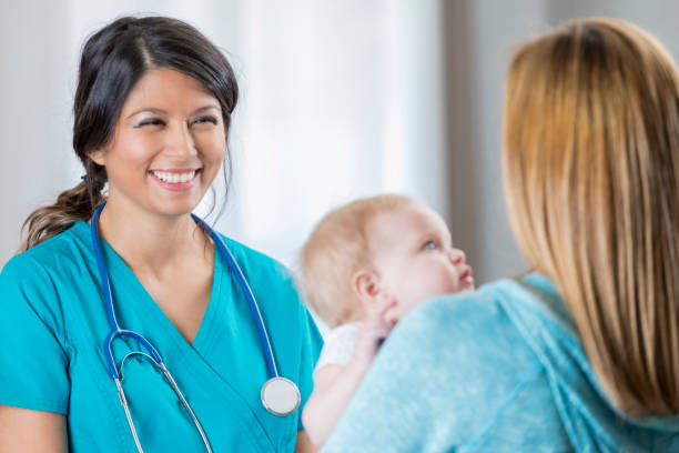 istock Confident Asian nurse talks with new mother during appointment 643782344