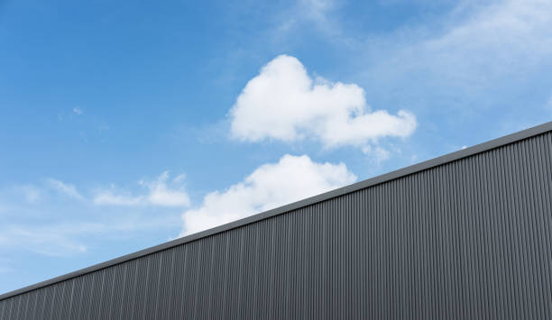 istock Corrugated factory industry wall on blue sky with clouds 643791622