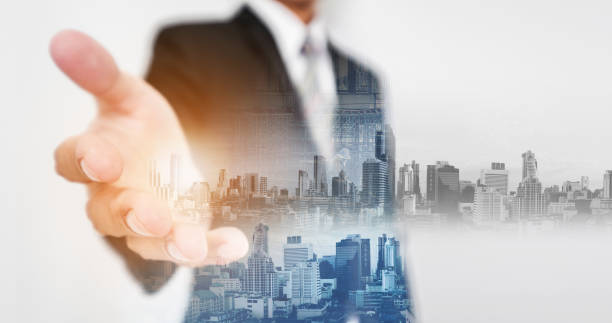 istock Double exposure businessman stretch out hand with modern buildings 643791624