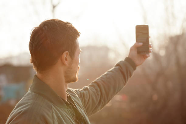 istock Handsome young man with beard taking selfie outdoor 643801232