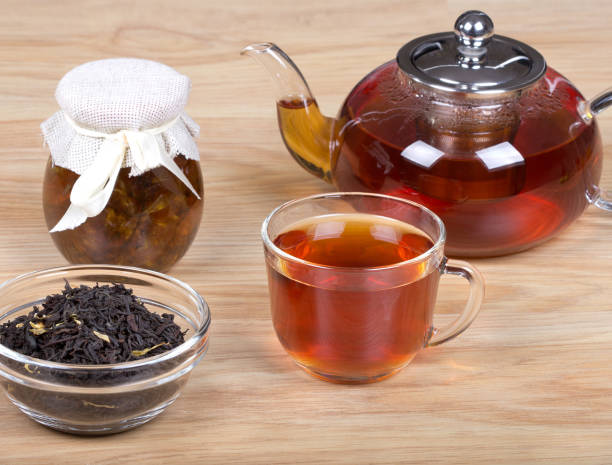 istock Cup of tea,teapot,jar of jam on table. 643825254