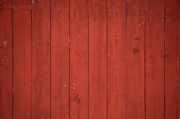 Vertical red barn boards and planks background Vertical oxblood red barn door boards and planks background. One red hinge. red barn house stock pictures, royalty-free photos & images