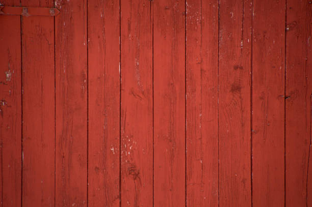 Vertical red barn boards and planks background Vertical oxblood red barn door boards and planks background. One red hinge. red barn wood stock pictures, royalty-free photos & images