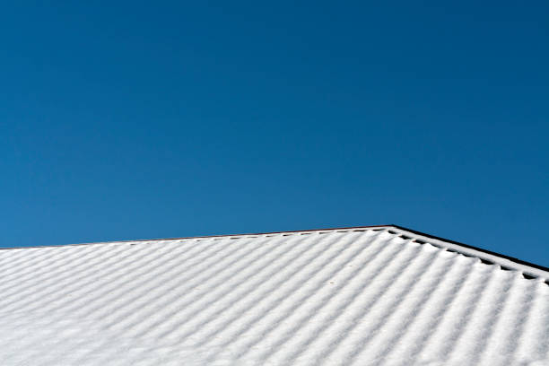 Residential house roof covered with snow. Seasonal background for your ideas.