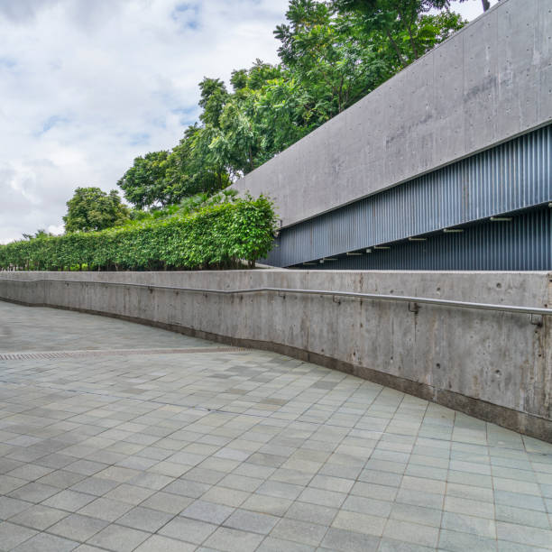istock perspective view of grey concrete wall with fresh trees 643839068