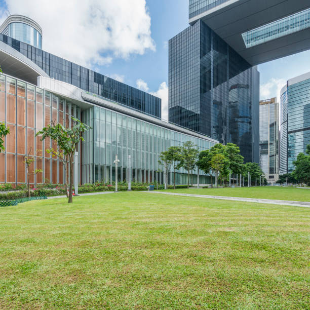 istock office block building with green lawn 643840144