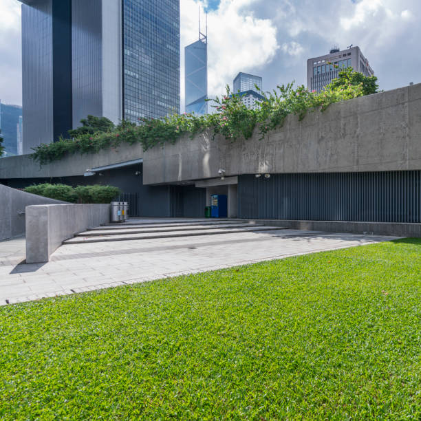 istock office block building with green lawn 643842958