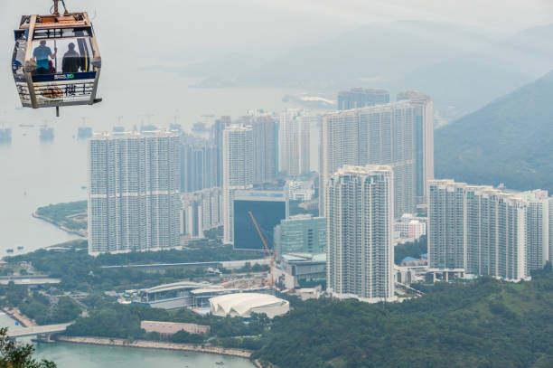 The Ngong Ping 360 is an aerial tramway on Lantau Island in Hong Kong. Photo taken contains the cable cars and passengers en route to the top of Lantau Island in Hong Kong.