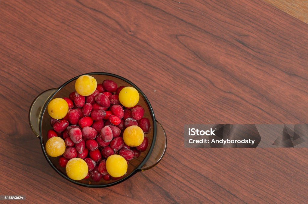 dish with frozen cherry plum and dogwood dish with frozen cherry plum and dogwood on table Autumn Stock Photo