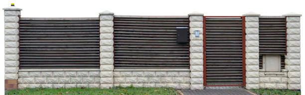 istock Long no name solid fence from wooden horizontal boards and columns which are revetted with a decorative cream color tiles. Isolated with patch panoramic collage 643844102