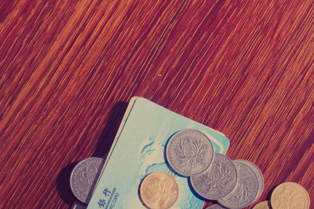 The credit cards and money on the business desk represent the money, savings