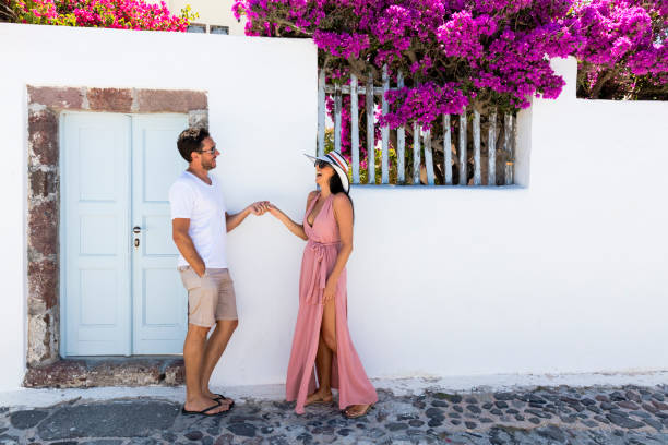 Happy romantic couple on Greek Island Happy romantic couple on sunny Greek Island happy couple on vacation in santorini greece stock pictures, royalty-free photos & images
