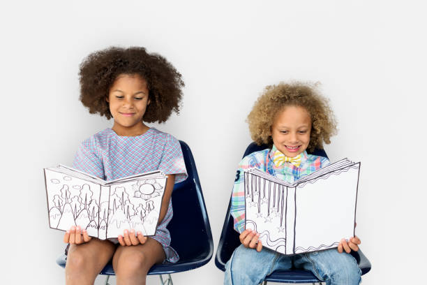 istock Little Children Reading Book Smile 643848120