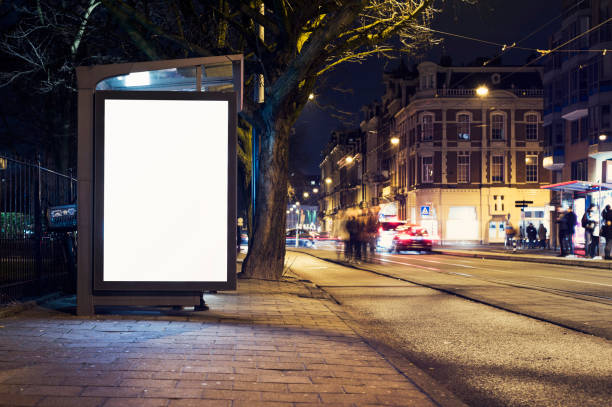 outdoor advertising billboard Outdoor advertising billboard or abri kiosk at nighttime in the city lightbox stock pictures, royalty-free photos & images