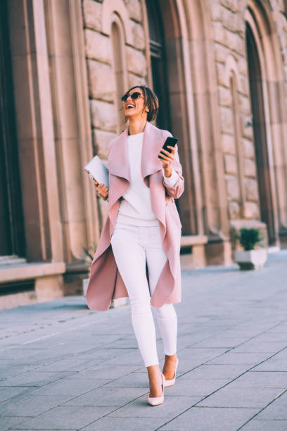 istock Beautiful elegant woman texting outdoors 643868344