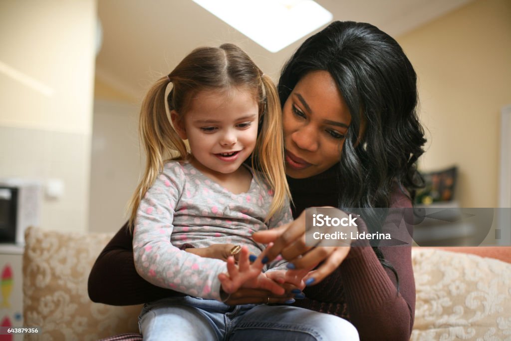 African American woman with child. African American woman playing with girl. Adoption Stock Photo