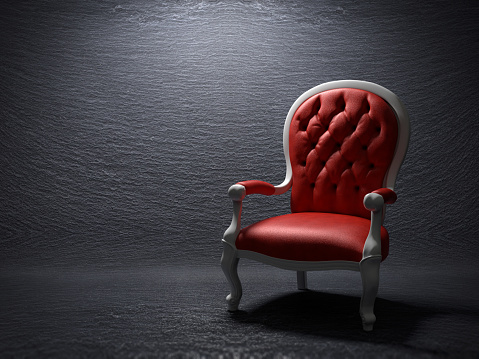 Red armchair on a slate stone background
