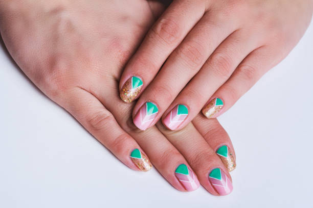 istock Nail art with bright gold, pink and green chevron pattern 643882490