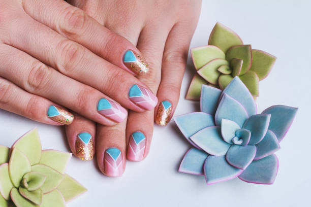 istock Nail art with bright gold pink and blue chevron pattern 643882606