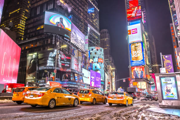 taxi gialli a times square manhattan di notte - times square foto e immagini stock