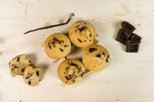 istock Muffin with chocolate drops and vanilla bean on wood background 643893590