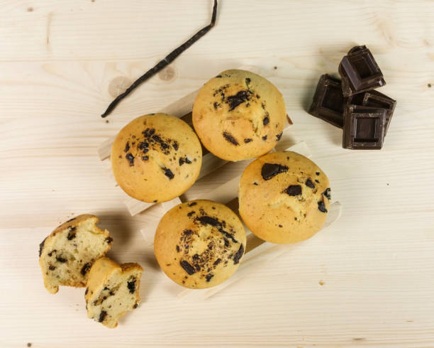 istock Muffin with chocolate drops and vanilla bean on wood background 643894014