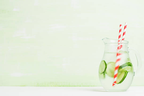 istock Cold water with cucumber and ice in pitcher 643894272