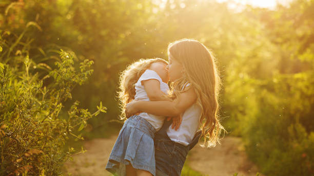 istock Two cute little sisters hugged strongly. 643897552