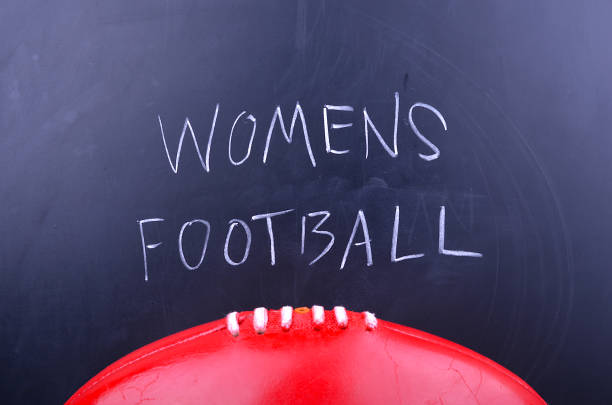 istock Females playing Australian rules Football 643898580