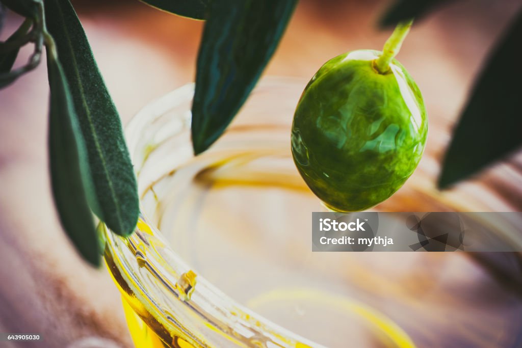 Olive oil Extra virgin healthy Olive oil with fresh olives on rustic wooden background Innocence Stock Photo