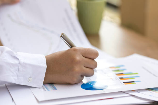 istock Businesswoman analyzing annual report 643905980