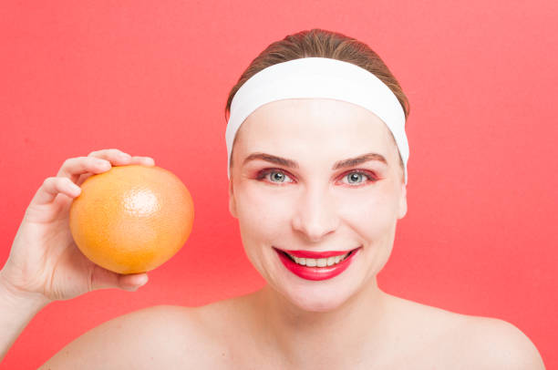 istock Female at spa showing fresh grapefruit 643916806