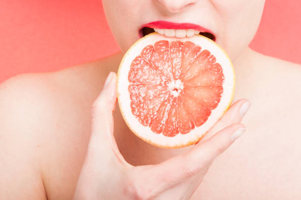 istock Female bite a slice of grapefruit 643919450
