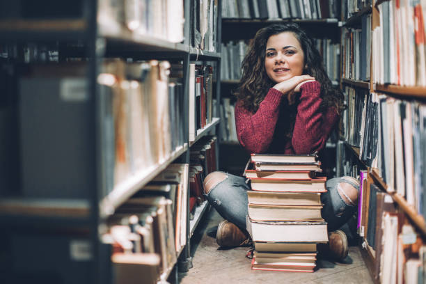 istock Student thinking of her upcoming exams in a library. 643919452
