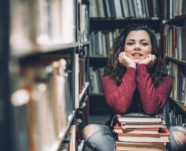 istock Student thinking of her upcoming exams in a library. 643919728
