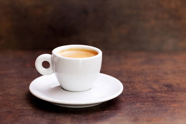 istock White cup of espresso coffee on background. 643921526