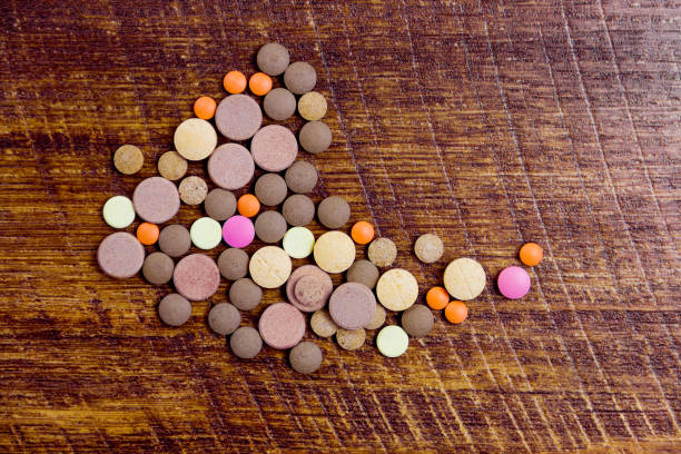 istock Colorful pills on wooden background 643926926