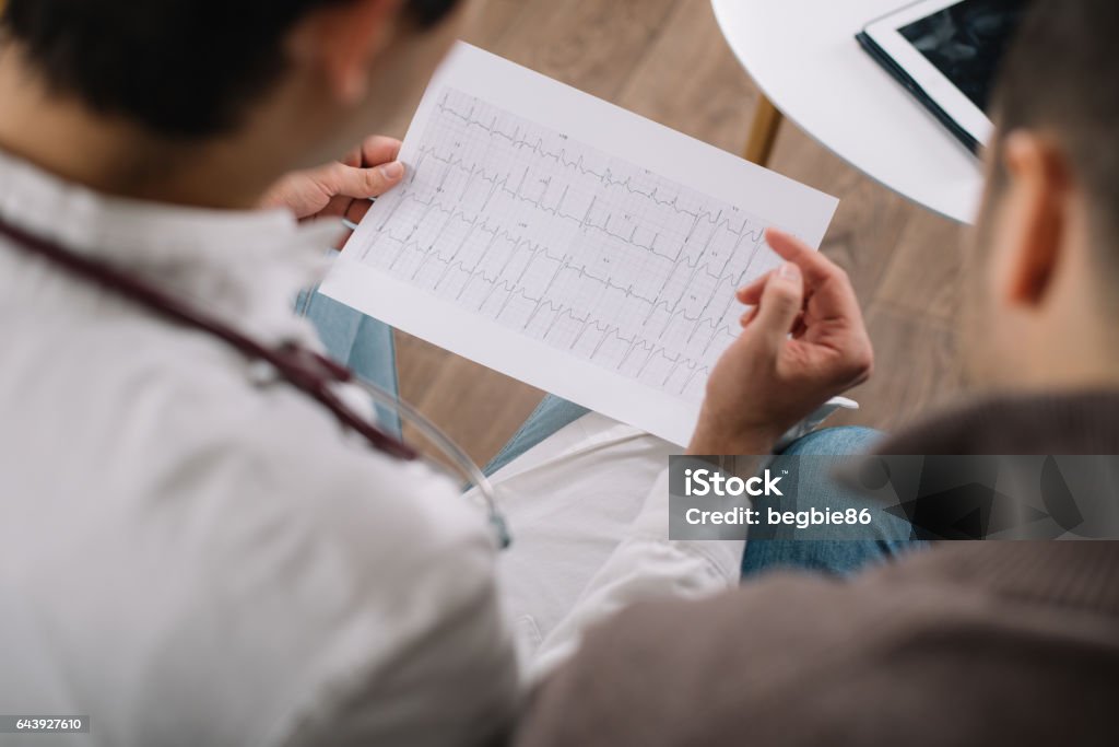 Doctor showing ECG results to a patient Electrocardiography Stock Photo