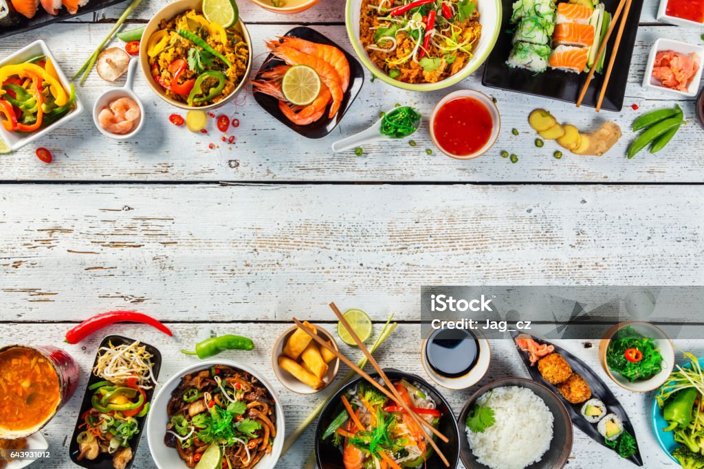 Asian food served on wooden table Asian food served on white wooden table, top view, space for text. Chinese and vietnamese cuisine set. Asian Food Stock Photo