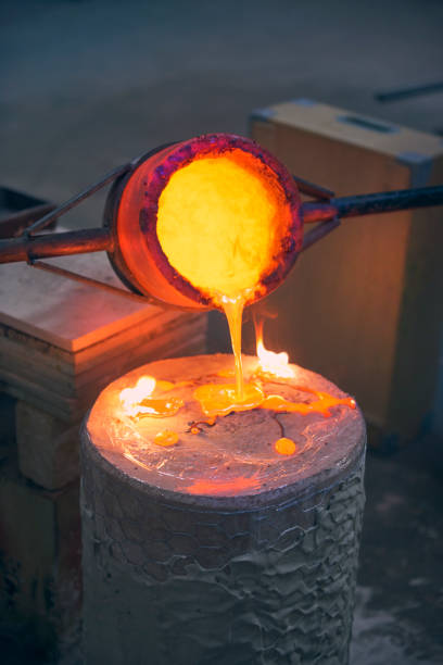 istock Artist fills mold with molten bronze 643931866