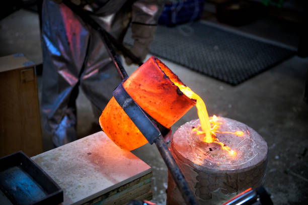 istock Artist fills mold with molten bronze 643932152